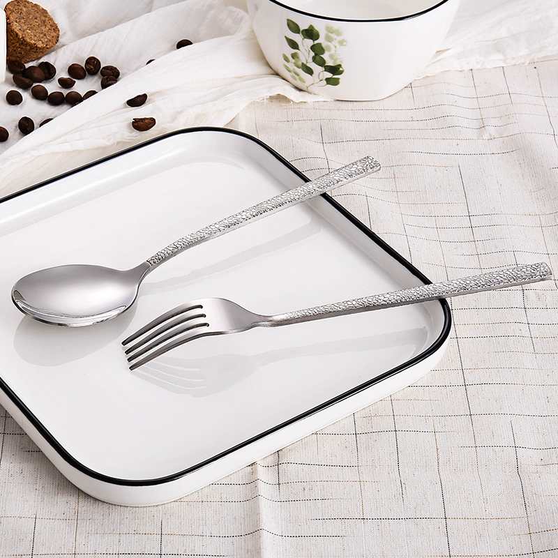 Colorful stainless steel cutlery set with padded handles and modern design

