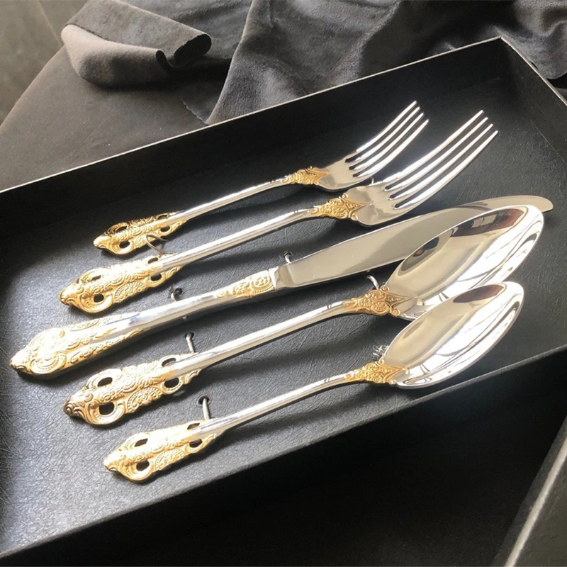 Stainless steel kitchen cutlery set including knife, fork, and spoon