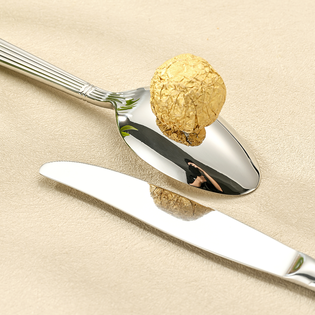 Stainless steel cutlery set including knife, fork, and spoon

