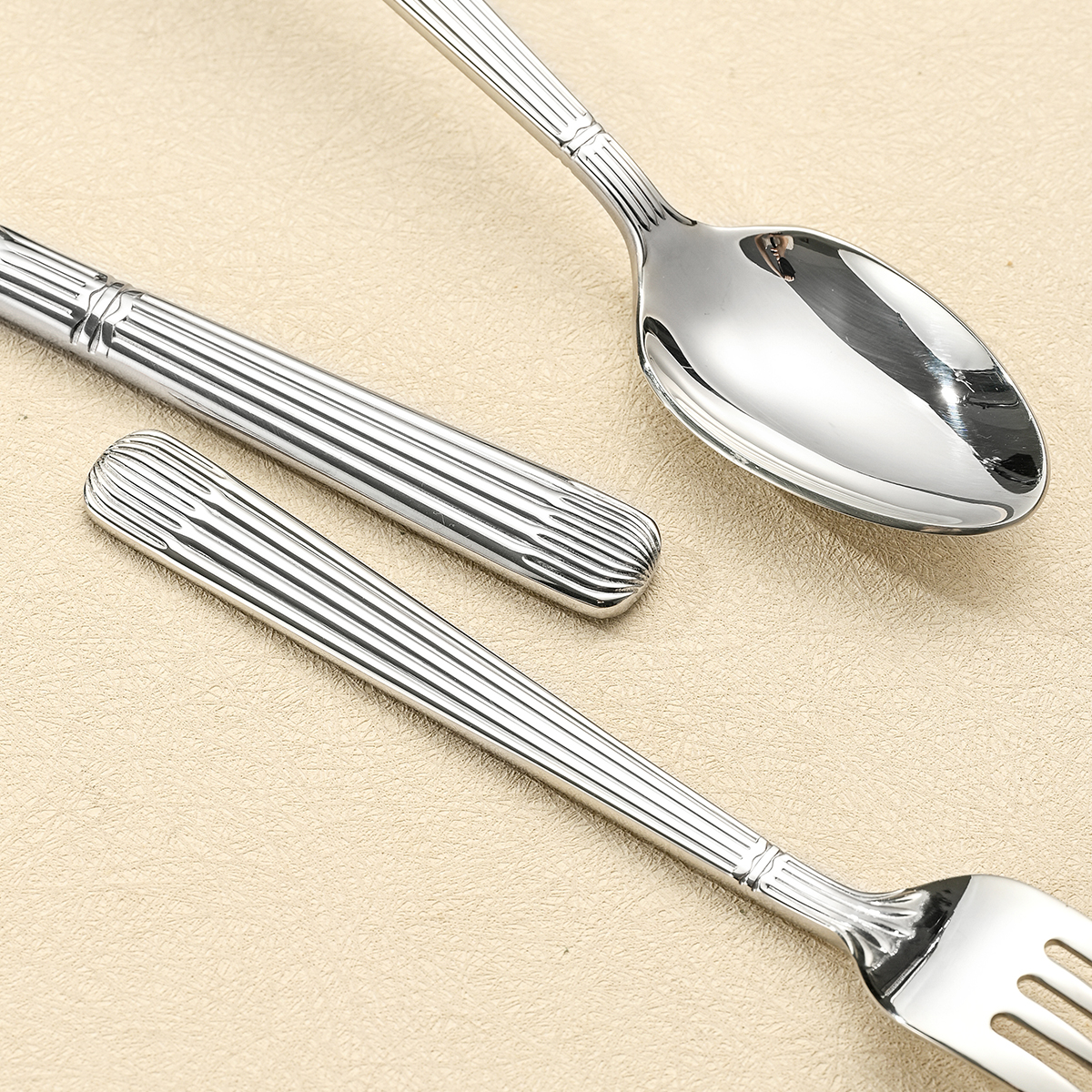 Stainless steel cutlery set including knife, fork, and spoon

