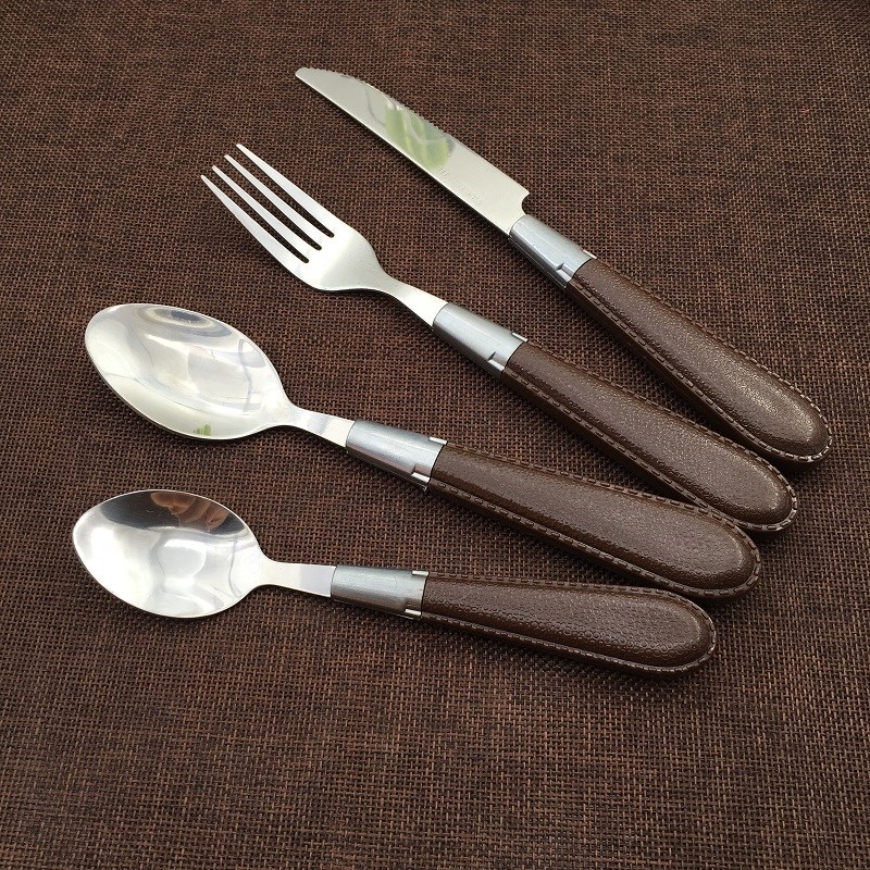 Luxury stainless steel cutlery set with leather handles, including spoon, fork, knife

