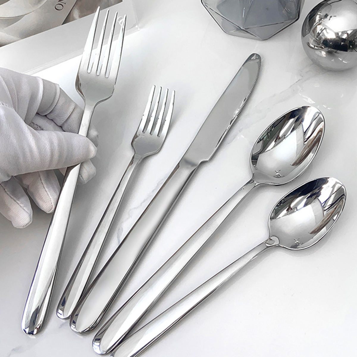 Luxury stainless steel cutlery set with leather handles, including spoon, fork, knife

