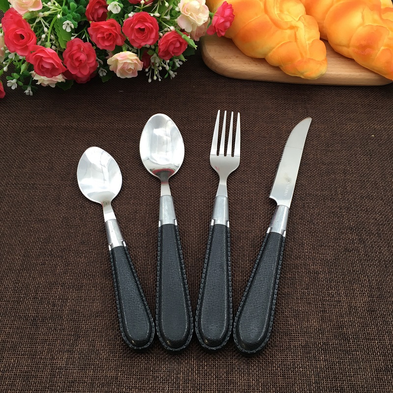 Luxury stainless steel cutlery set with leather handles, including spoon, fork, knife

