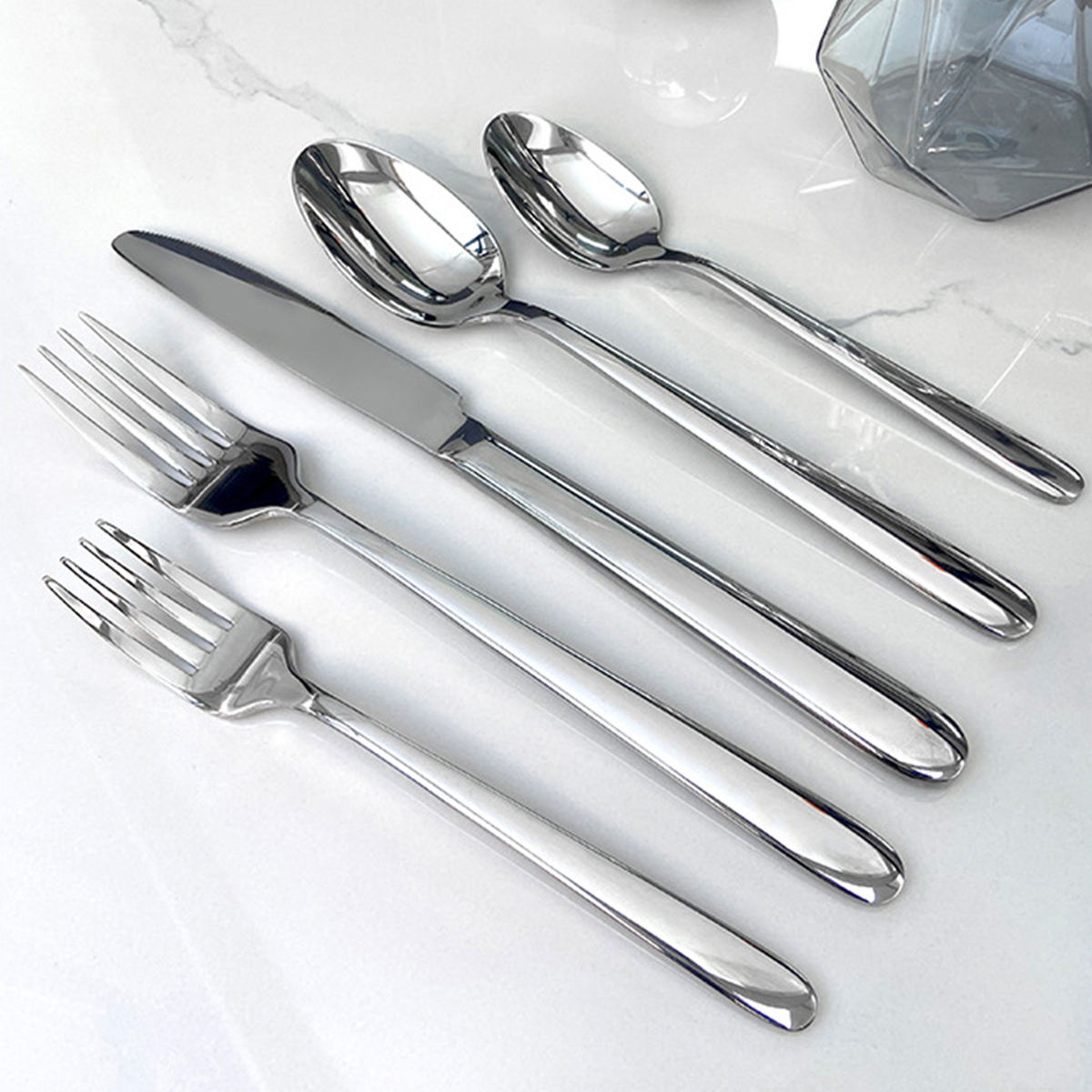 Luxury stainless steel cutlery set with leather handles, including spoon, fork, knife

