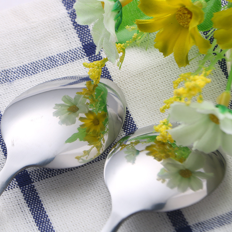 Modern stainless steel cutlery set with wooden handles for elegant dining

