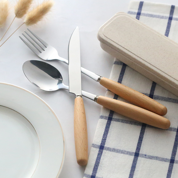 Modern stainless steel cutlery set with wooden handles for elegant dining


