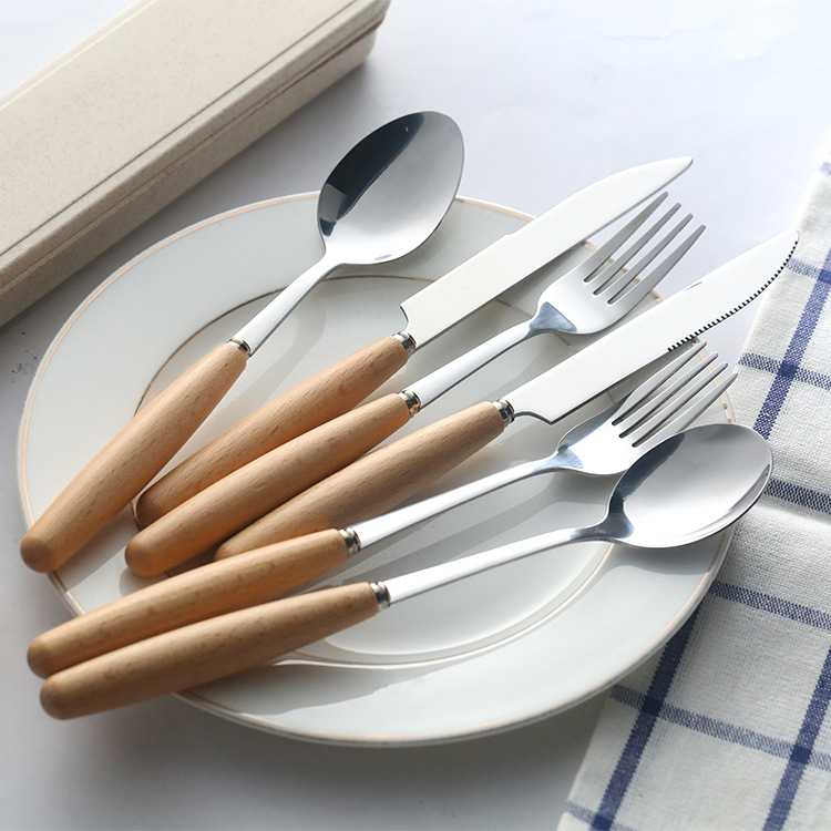 Modern stainless steel cutlery set with wooden handles for elegant dining

