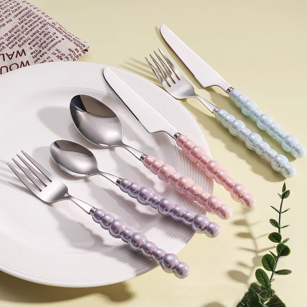 Colorful ceramic handle cutlery set with fork, knife, and spoon

