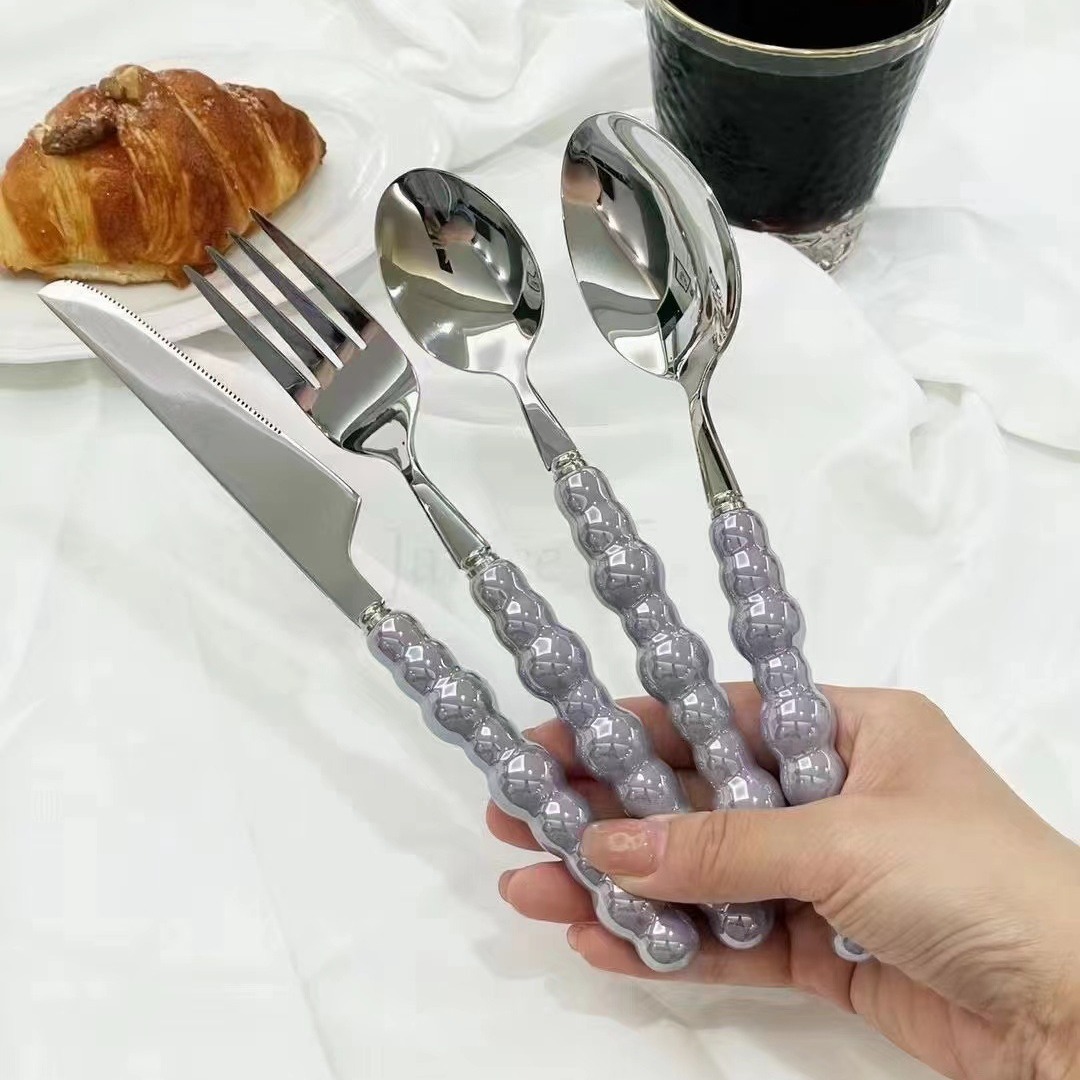 Colorful ceramic handle cutlery set with fork, knife, and spoon

