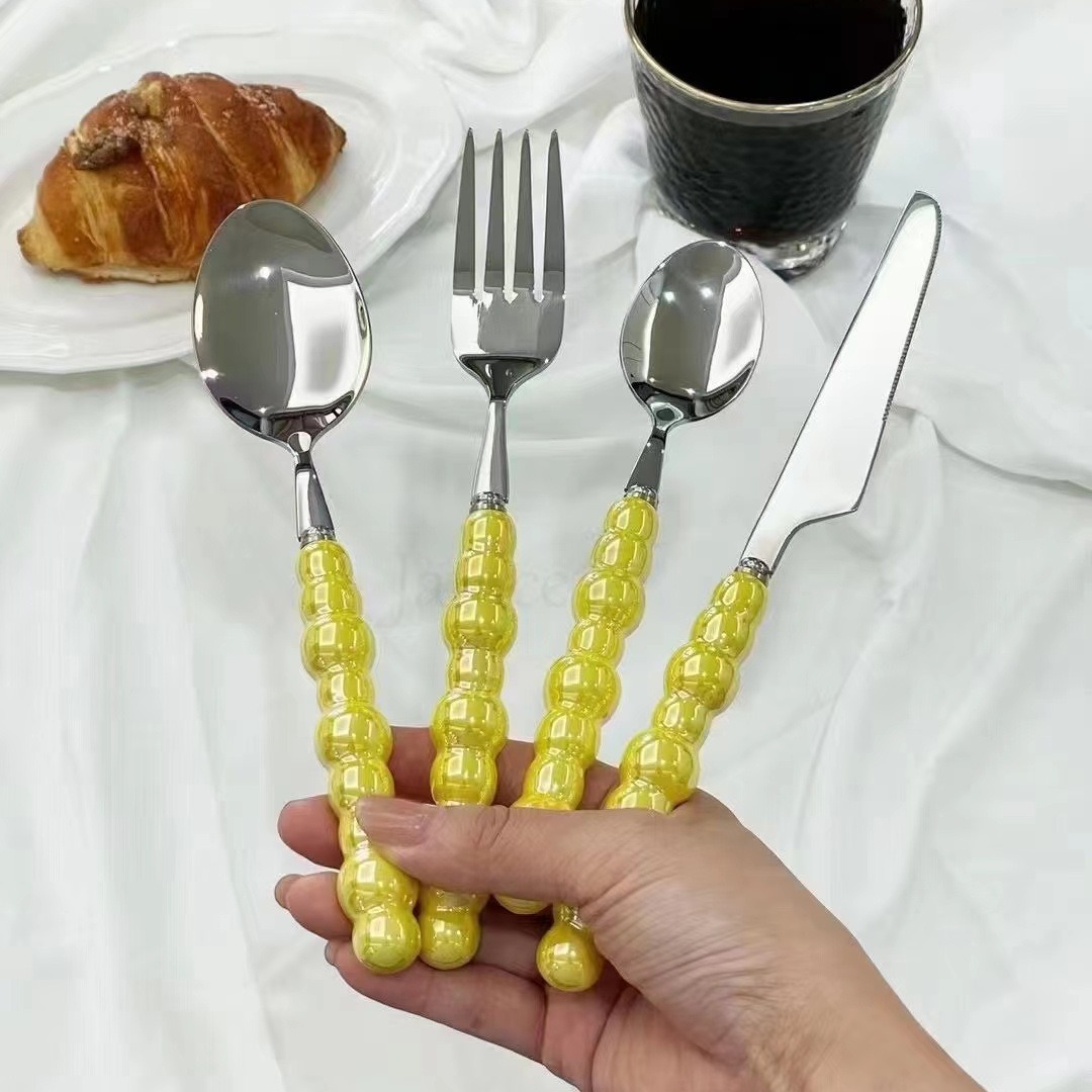 Colorful ceramic handle cutlery set with fork, knife, and spoon

