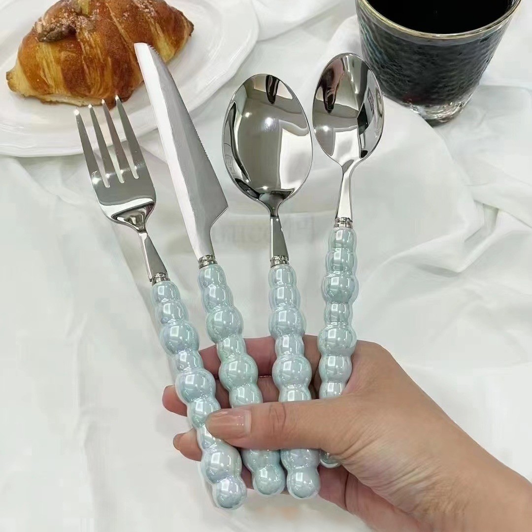 Colorful ceramic handle cutlery set with fork, knife, and spoon

